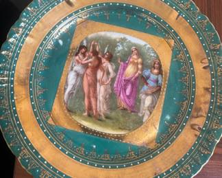 This antique decorative plate appears to be from the Imperial Crown China factory in Austria, featuring a hand-painted scene of women in a field.