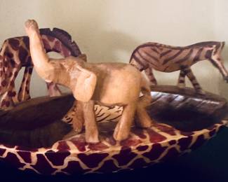 This Stoneage Arts safari bowl is hand-carved from African Jacaranda wood and features intricate animal figures along its rim