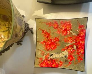 decorative bowl features a gold foil lacquer finish with hand-painted red cherry blossoms.It is designed in an Asian style, consistent with Japanese or Vietnamese lacquerware techniques.