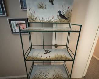 vintage wrought iron baker's rack features a green metal frame and hand-painted duck scenery on the top arch and shelves.