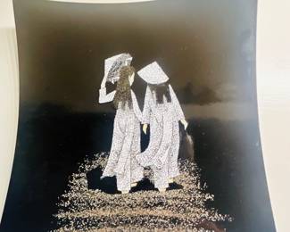 This handmade Vietnamese lacquer wall art features a mosaic design crafted from crushed eggshell fragments.The piece depicts two women in traditional Ao Dai dresses walking together.It is created by inlaying the eggshell fragments into natural lacquer resin on a wood plaque, followed by sanding and polishing for a smooth finish