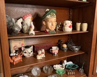 Assorted Vintage Collectibles Display with Figurines, Glassware, and Ephemera
