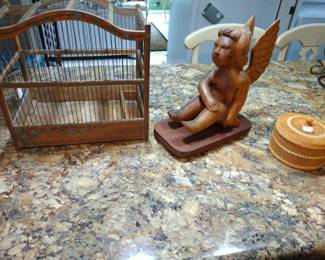 Vintage birdcage, angel carving, and hand woven lidded baskets.