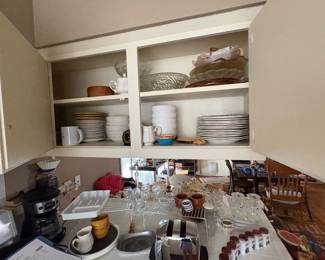 Miscellaneous kitchen items, including plates, wine, glasses, etc.
