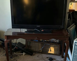 Lot 409: Sharp LCD TV with wooden console table