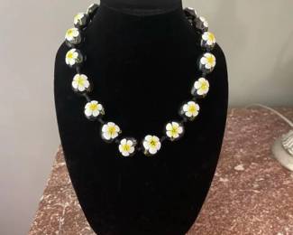 Hawaiianstyle Kukui Nut Lei Necklace Features Black Polished Nuts HandPainted With White Hibiscus
