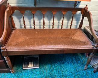 cute antique bench with woven rush seat