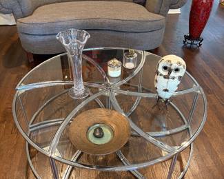Charcoal grey loveseat with single cushion, 6-piece round chrome and glass coffee/cocktail table, Cashmere throw, Italian crystal vase, Michael Aram candles and storage containers, ceramic owl and pottery dish and tall vase