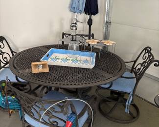 Round cast aluminum patio table with 4 "Rocker" armchairs and umbrellas with stands