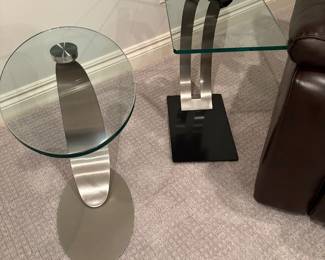 Side tables in brushed stainless bases with glass tops