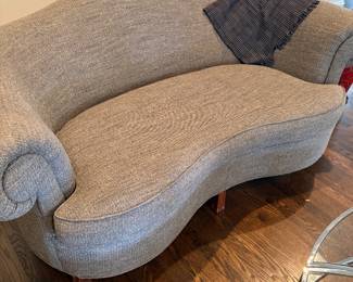 Art-deco styled loveseat with attached back and single cushion