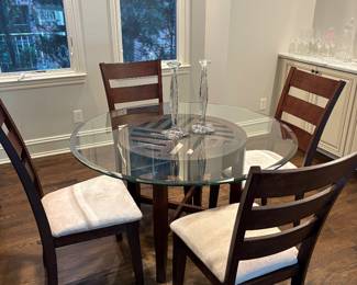 Round glass topped table with wood base and 4 side chairs