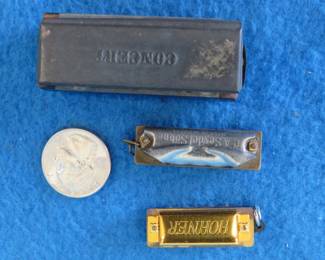 Lot 168. Two older and one newer mini novelty harmonicas: C.A. Seydel Sohne 1 3/4" Little Bandmaster with poor sound. Hohner 1 3/8" newer miniature 4-hole harmonica with great sound. Unknown maker 12-hole harmonica with poor sound.