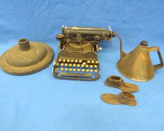 Lot 305. Cast iron sign post base, Corona typewriter for parts or repair, shoe lasts, and an old oil can