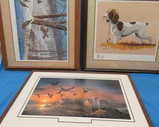 Lot 256. Three framed prints: 33" x 27" Winter Gathering by Rynard Klinbeil. Note the personal inscription on the back. There appears to be some spots on the bottom of the print. 29" x 28" Whistle Trained - English Springer Spaniel by harry Tollas. 34" x 25.5" Sundown by Terry Redlin in fair condition. No glass.