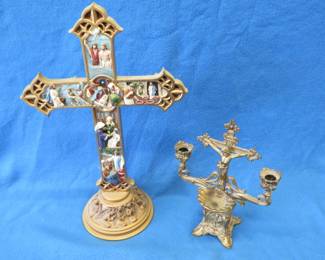 Lot 120. A resin crucifix with Christ on the cross and engravings marking different stories from the Bible, and a brass crucifix candlestick/holy water holder