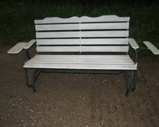 Lot 201. Outdoor glider/rocker. Primer applied and waiting for your color scheme. One arm rest needs replacement.