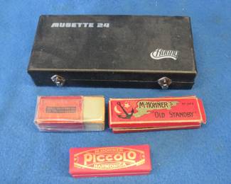 Lot 169. Four empty harmonica boxes, including Hohner Piccolo, Hohner's "Old Standby" in poor condition, half a Hohner box, and a Huang Musette box