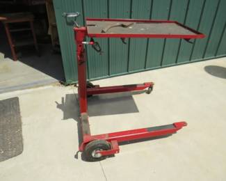 Lot 327. Adjustable height rolling shop table. Missing one caster
