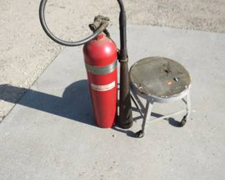 Lot 279. 1944 U.S. Navy 15 lb. CO2 fire extinguisher and a shop stool