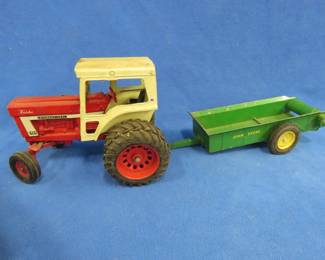 Lot 232. Turbo International Tractor 1466 Farmall and a John Deere trailer