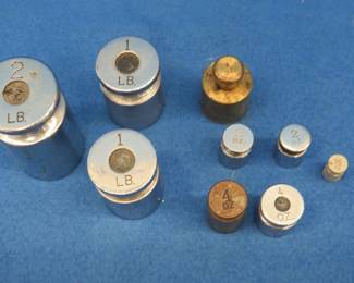 Lot 304. Set of scale weights as pictured. 2 lbs. down to 1/2 ounce.
