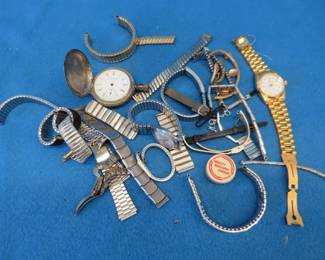 Lot 38. Watches, watch bands, watch parts, a pocket watch in a coin silver case, and a fake Rolex. All untested.