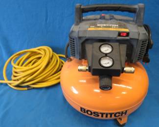 Lot 137. Bostitch 6-gallon pancake compressor with a hose