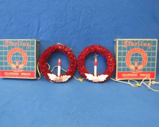 Lot 25. Two vintage Sterling cellophane Christmas wreaths. Both in good working condition with their original boxes.