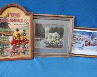 Lot 259. Three framed prints: 26.5" x 17.5" Fins Guide Service and Co. with canoe and more applique. 22" x 16" Grumpy Old Men by Jan Perdew. 24" x 22" Church scene in a barn wood frame.