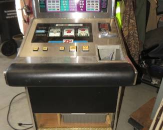 Lot 322. 1992 IGT slot machine with tokens. No key. Door is open