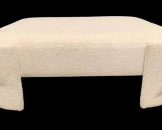 322 - Wildwood Prix Ottoman - Boucle (Description): 17 x 49 x 49, some spots need cleaning, Introducing our Prix Ottoman, a stunning piece of furniture that effortlessly blends contemporary design with luxurious comfort. Wrapped in soft, performance boucl fabric (poly blend), this ottoman exudes a warm, inviting charm, making it a perfect addition to any space in your home. The square ottoman showcases a unique, curved silhouette with rounded edges, adding a touch of