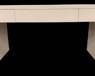 244 - Chelsea House Summit Desk (Description): 31 x 55 x 28, Retail $3586, The faux shagreen texture adds depth and visual interest, while the creamy color palette imbues a sense of tranquility and refinement to any space. The Summit Desk shape, with its gracefully curved silhouette, adds a touch of classic charm, making it a versatile addition to both traditional and contemporary interiors. Designed by Elizabeth Wicker.