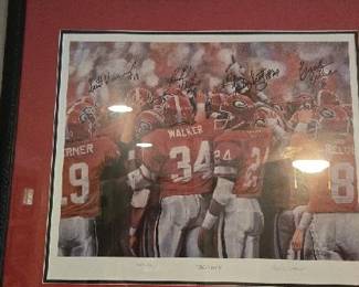 Glory Days" commemorative item featuring the 1980 University of Georgia National Championship football team by artist Noah Stokes.The artwork showcases key players like Herschel Walker (number 34), Scott Woerner, Lindsay Scott, and Buck Belue celebrating.