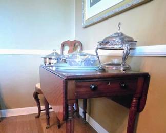 Antique mahogany drop-leaf table resembles 19th-century English Regency or American Federal Sheraton styles, featuring fluted legs a single drawer Patriots brass casters for Mobility beautiful mahogany family heirloom ( these are also known as the Pembroke breakfast table)