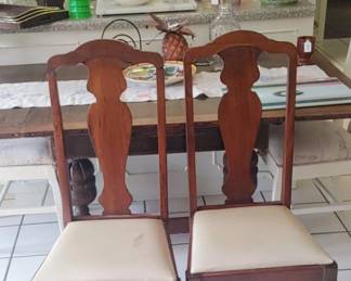 2 Queen Anne dining chairs feature curvaceous wood frames and distinctive cabriole legs.Style: Queen Anne style with spoon-style feet.