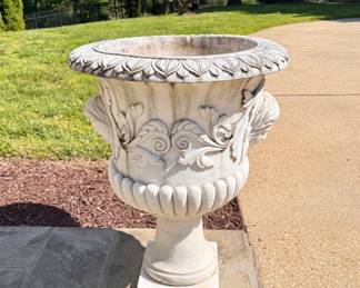 Side view of large marble planters with faces