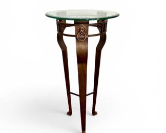 Tall metal table with glass top and 3 Lion head accents
