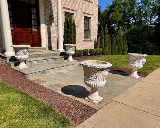 Front of house - 4 large, heavy marble footed planters with carved faces