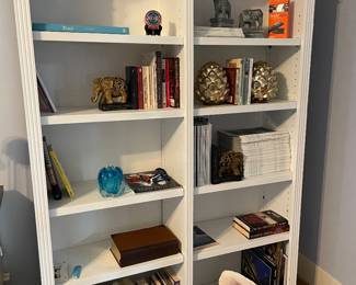 Double white book shelf, books, and bookends