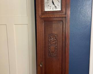 Tall Case Clock with bookshelves behind door