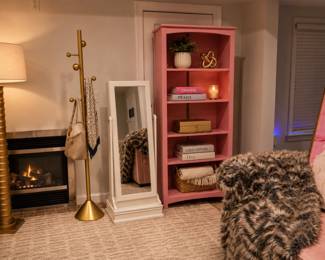 Gold lamp, gold coat rack, pink bookshelf & white mirror swivel jewelry stand