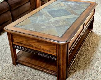 Nice Coffe table with inlaid stone top and the top lifts up towards you for eating at 