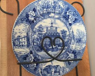 Colonial Williamsburg blue and white plate among plates with wall plate rack