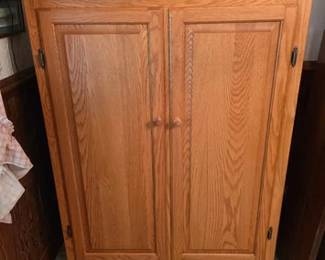 Solid oak storage cabinet with raised panel doors