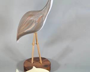 Signed heron wood carving and John Perry dolphins sculpture