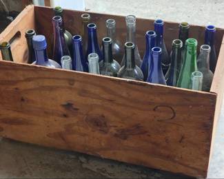 Collection of various wine bottles in wood box