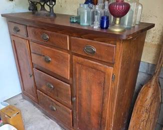 Vintage cabinet, Fairbanks balance scale and collection of glass bottles