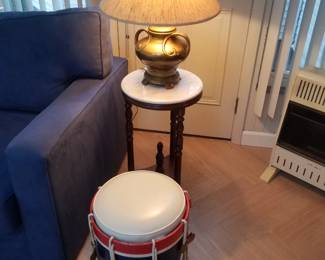 Drum storage stool; marble top table; table lamp