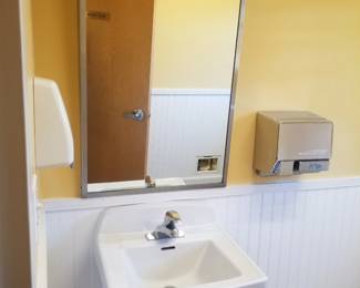 Commercial mirror; sink; paper towel dispenser